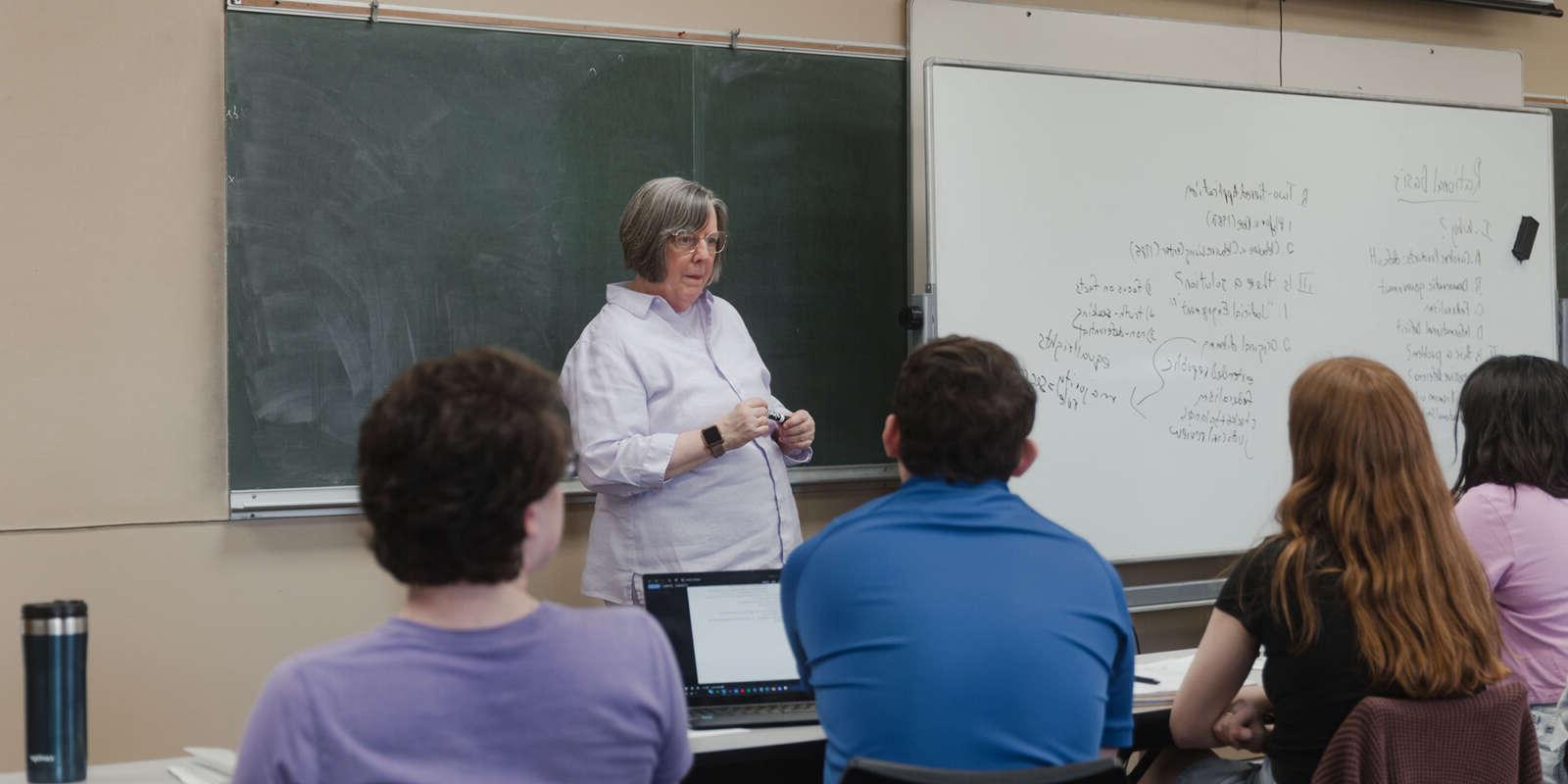 Dean Shankman teaching a Political Science class with a whiteboard